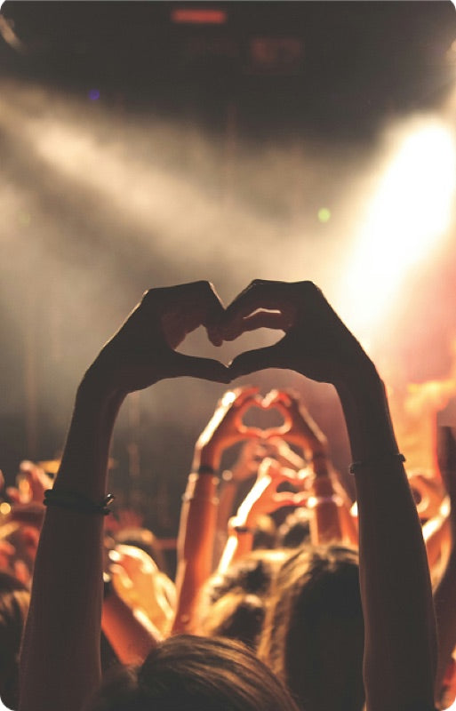 Hands making a heart at a festival